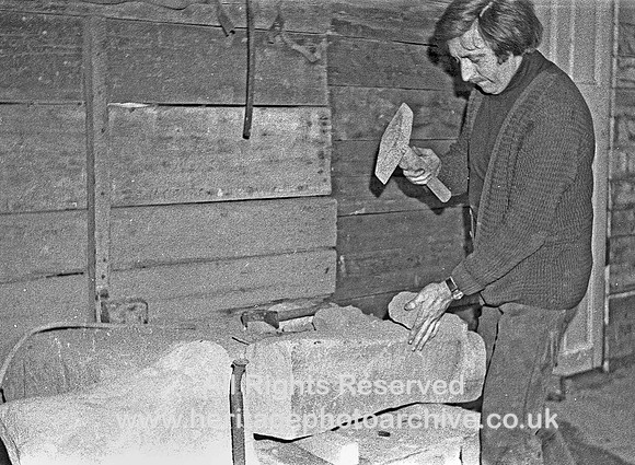 HRS 4520 Eli Whalley (1) breaking stone ready for grinding and mixing 1970s