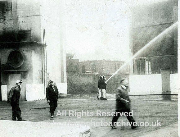 HRS 2048 Man walks across pit yard firemen hoses